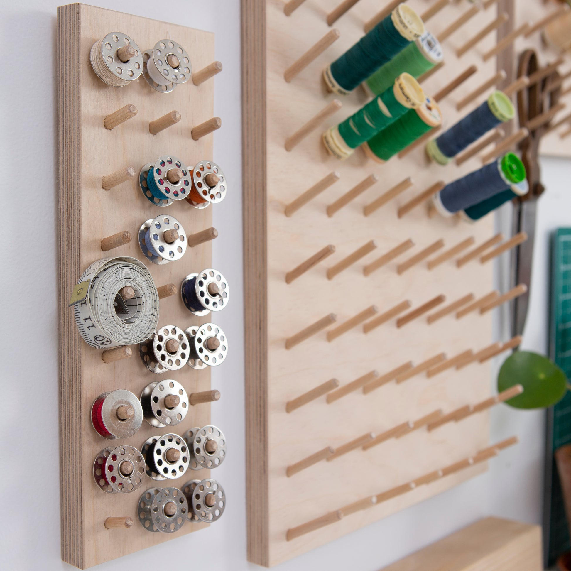 Bobbins organised on a wall hung pegboard