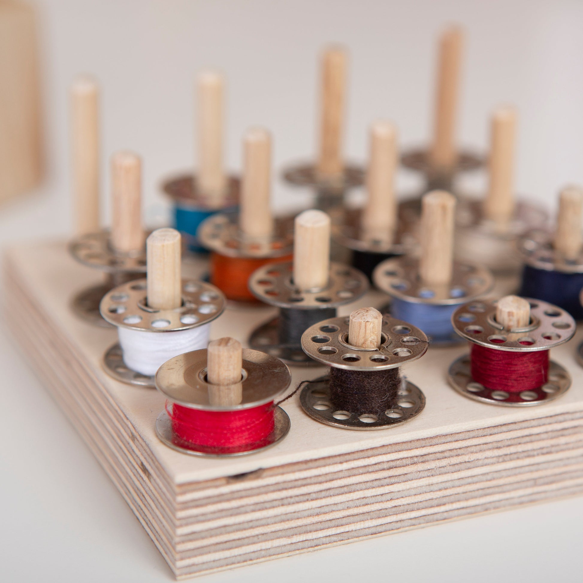 Sewing desk bobbin storage