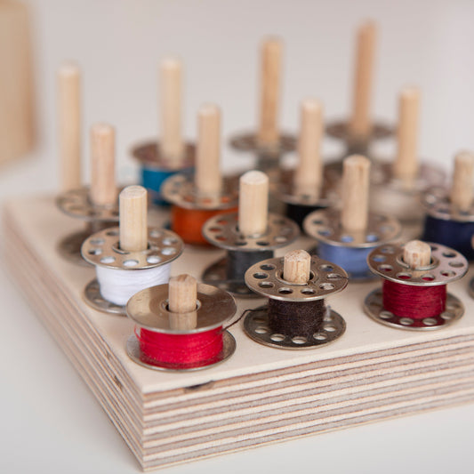 Sewing desk bobbin storage