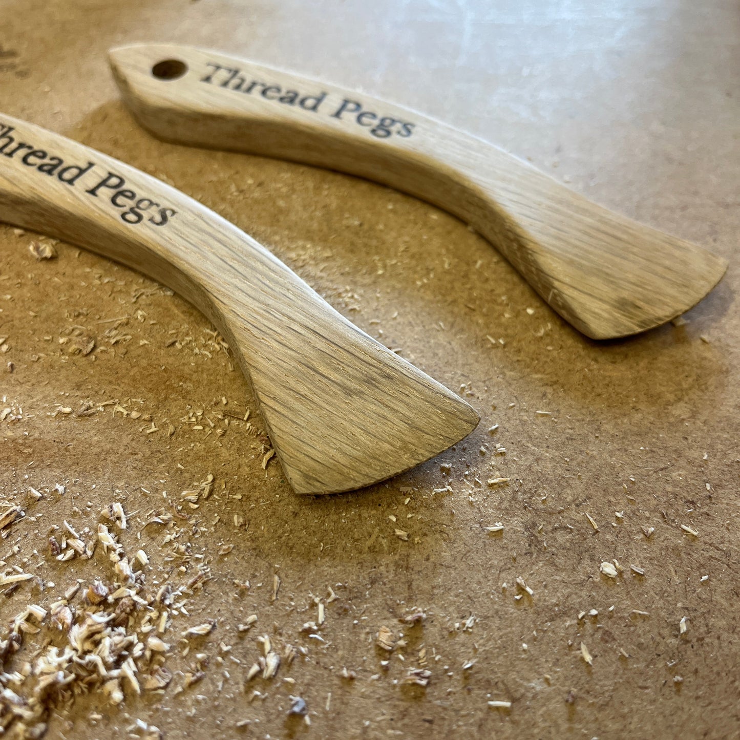 Two wooden Hera Markers on a table.