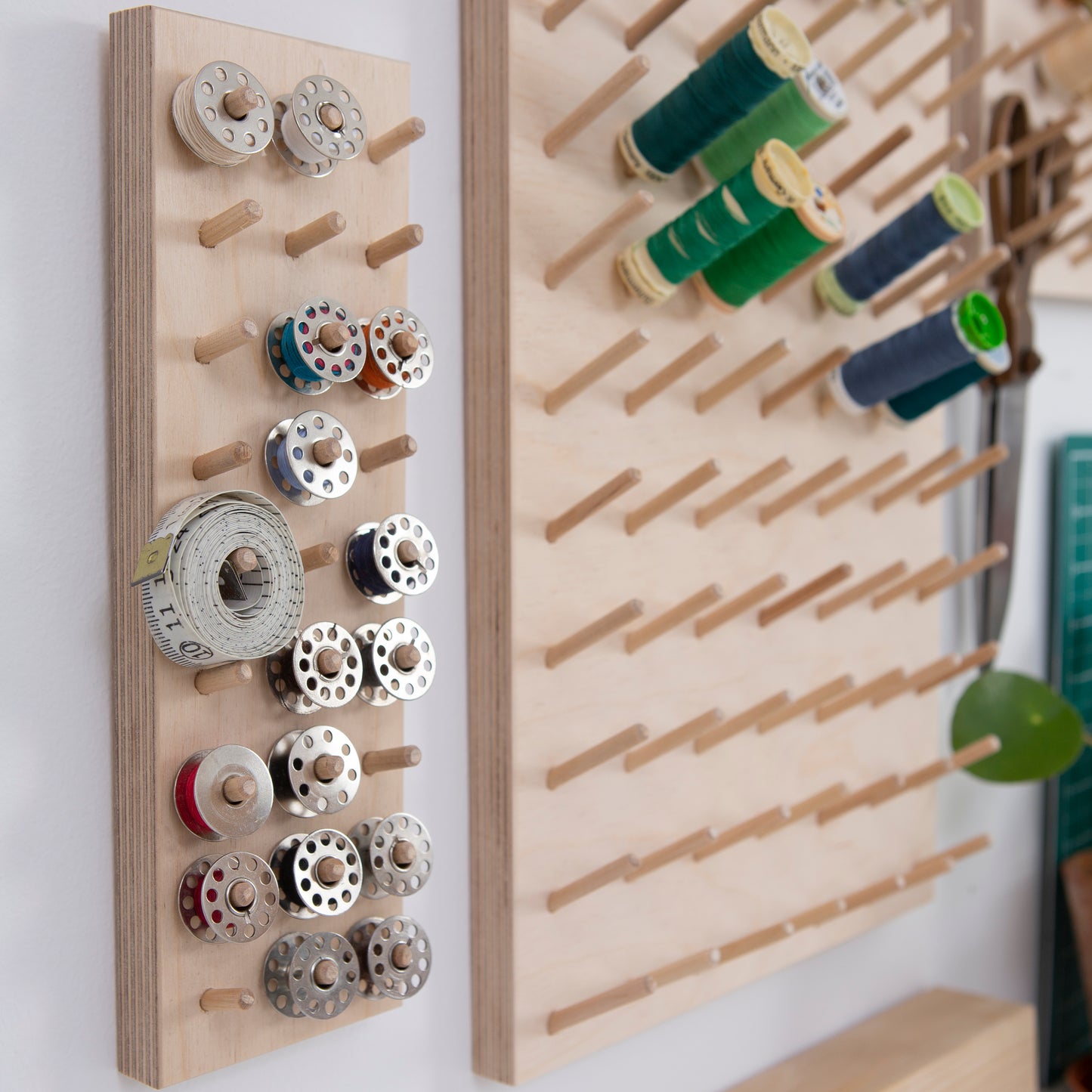 Bobbins organised on a wall hung pegboard