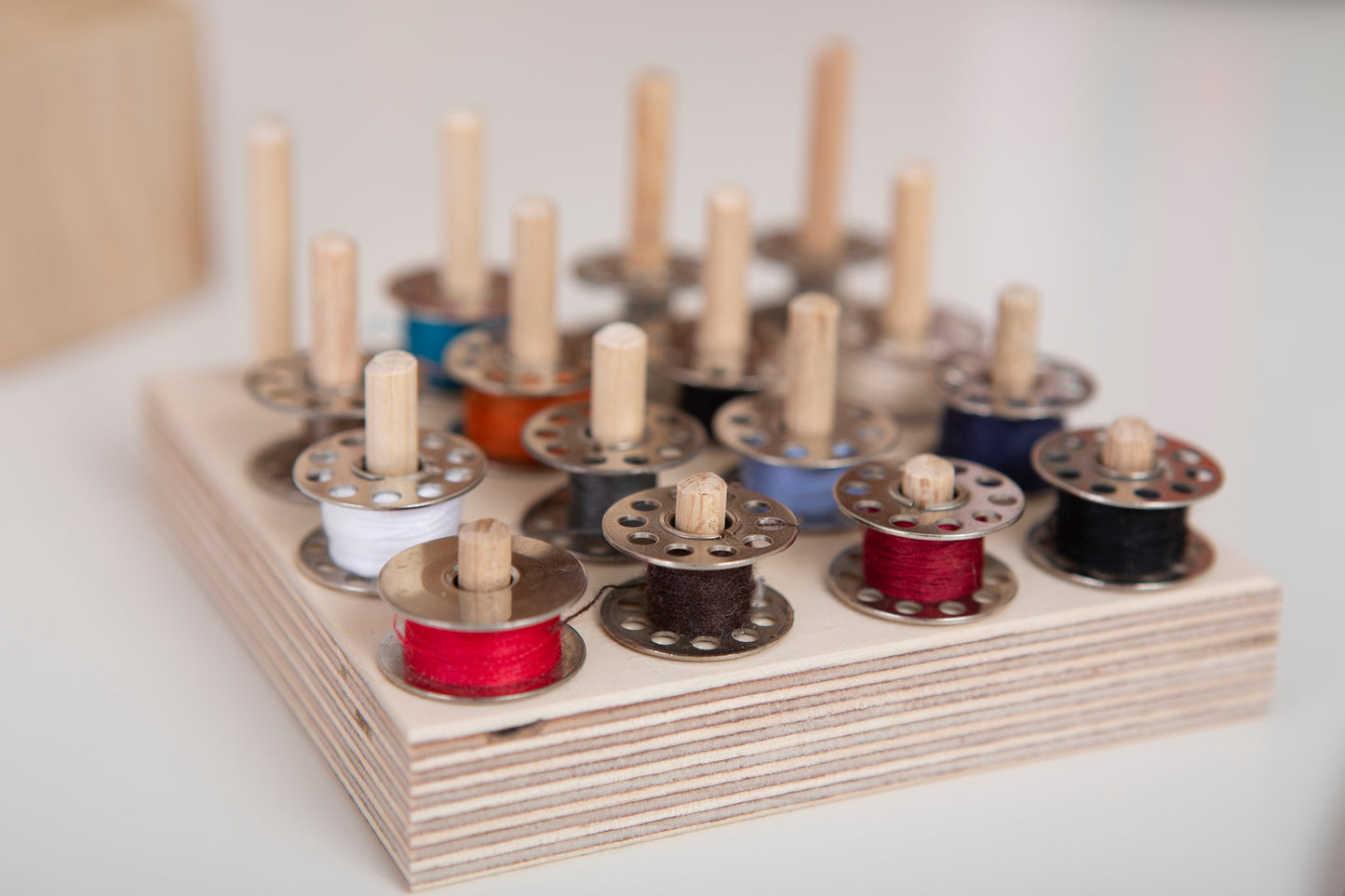 Sewing desk bobbin storage