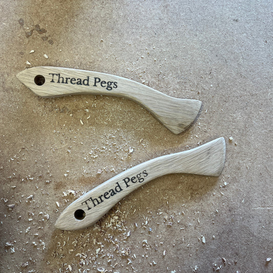 Two wooden Hera Markers on a textured surface