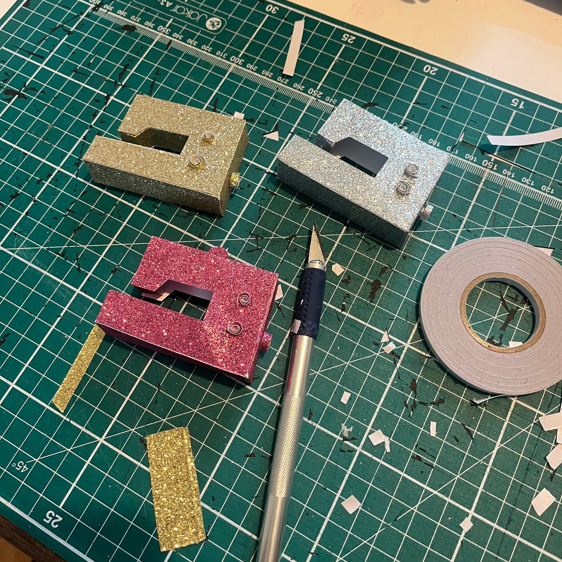 three miniature sewing machines made for decorating your christmas tree