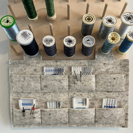 Needles in pouches on pegboard