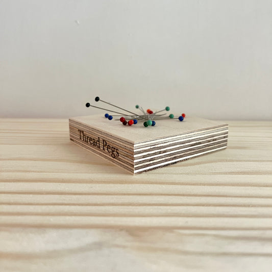 Magnetic pin holder made by Thread Pegs  with pins on top.