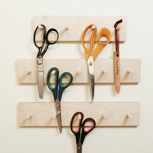 Scissor wall hooks on wall