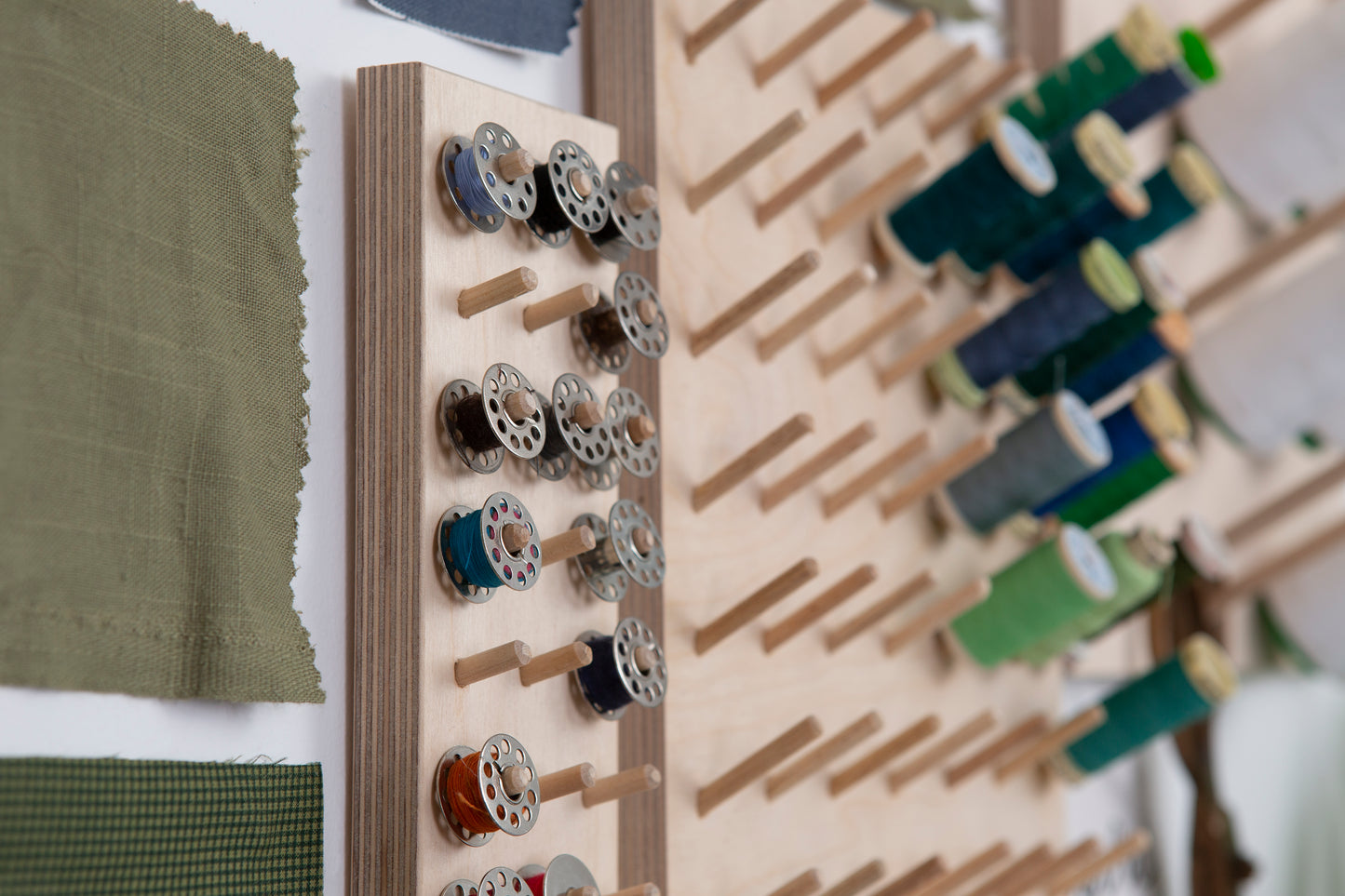 Detail of sewing bobbin stored on wall