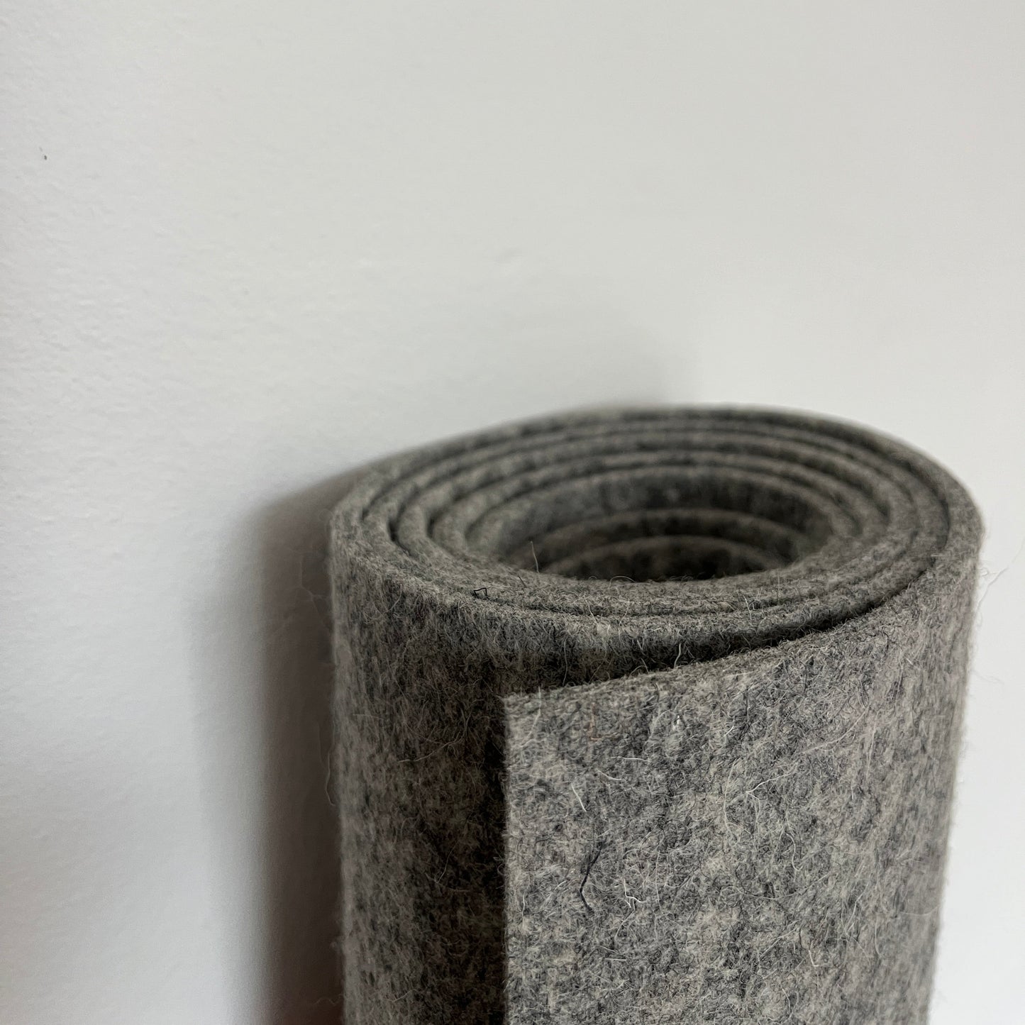 Grey wool felt rolled up