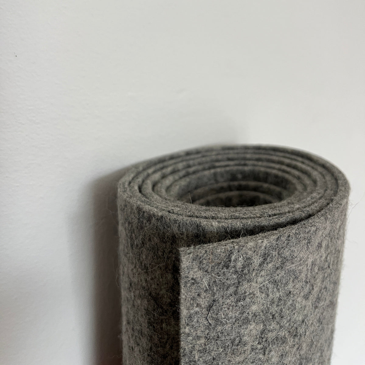 Grey wool felt rolled up